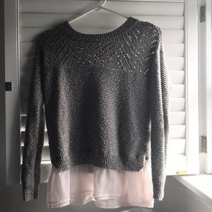 gray cotton sweater with pinkish flair on bottom